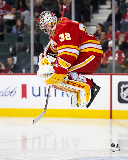 Pre-Order - Dustin Wolf Autographed Calgary Flames Home Jumping 8x10 Photo