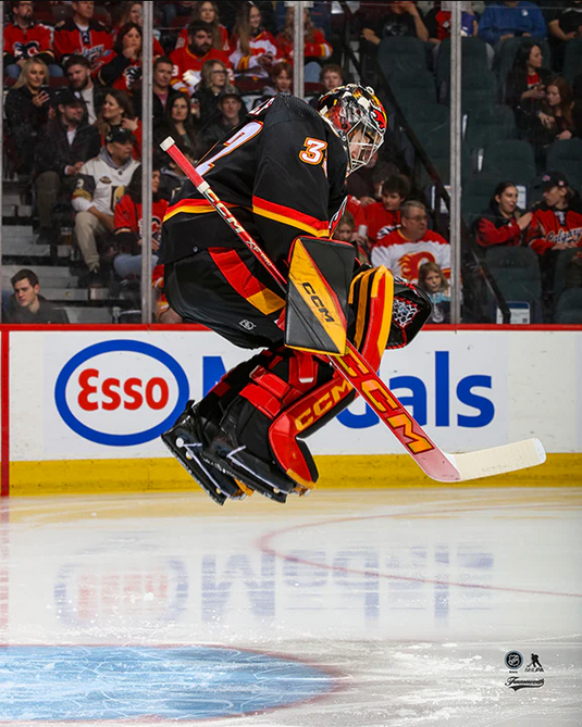 Pre-Order - Dustin Wolf Autographed Calgary Flames Alternate Jumping 8x10 Photo