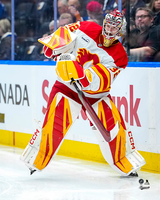 Pre-Order - Dustin Wolf Autographed Calgary Flames Passing Puck 8x10 Photo